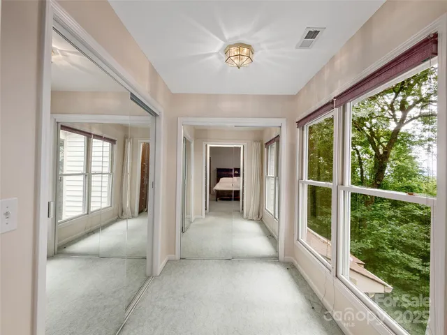 a view of a big room with windows and entryway