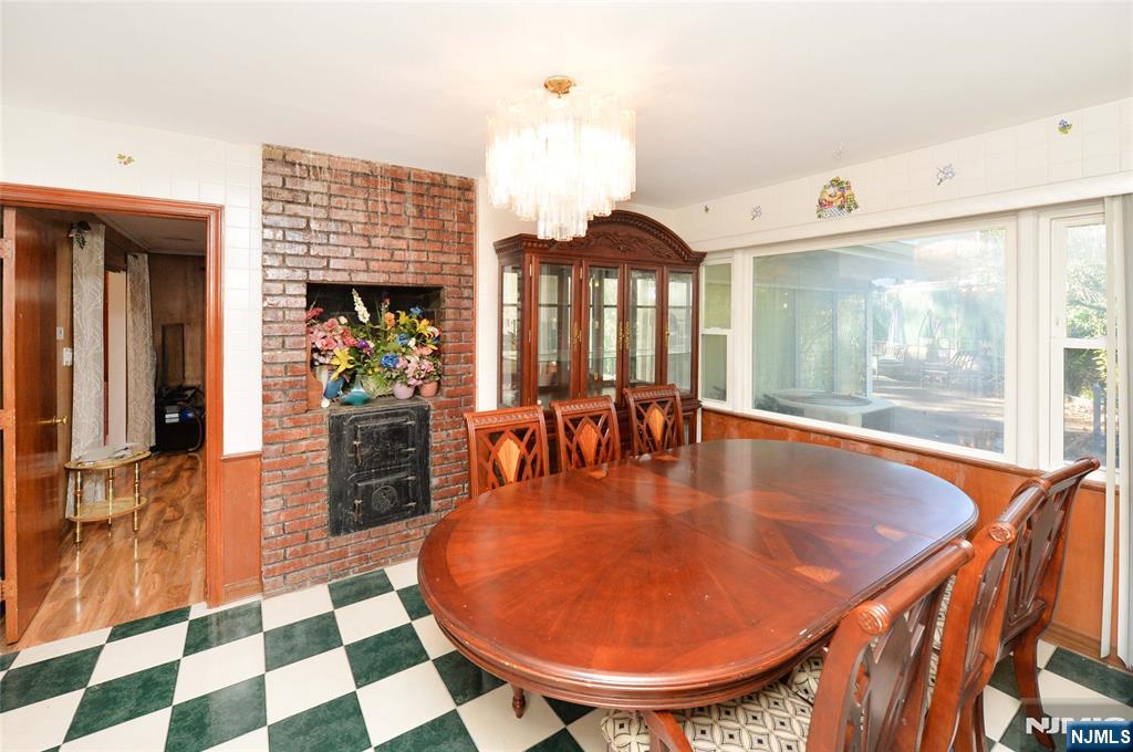 a dining room with furniture and a large window