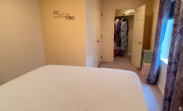 1797 Sunset Road Enoch, UT 84721 - Photo 42 of 80 Carpeted room featuring a window with patterned drapes, a built-in closet with a white paneled door, and neutral-toned walls