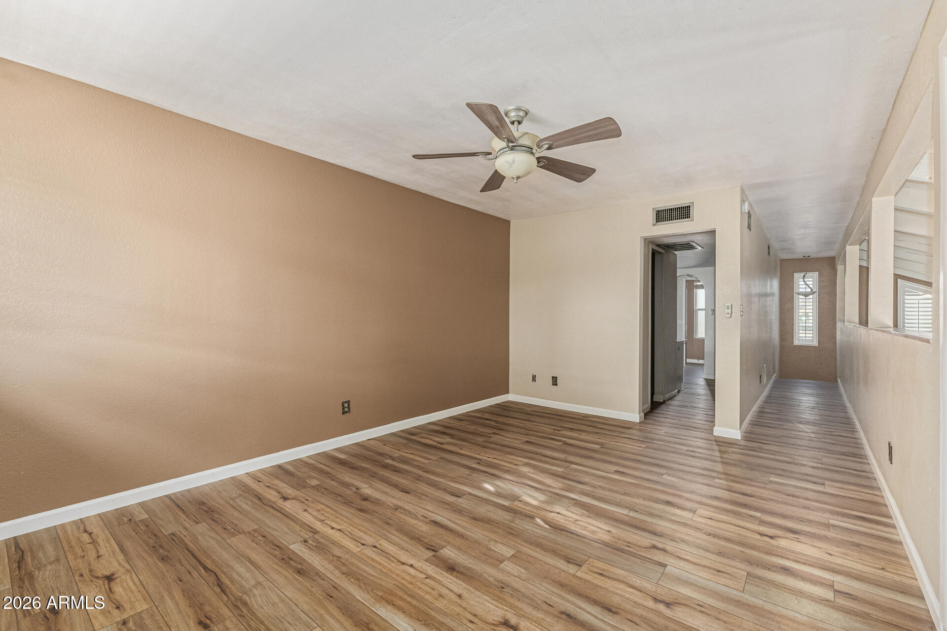 2930 North 22nd Place Phoenix, AZ 85016 - Photo 20 of 41 a view of empty room with wooden floor and fan