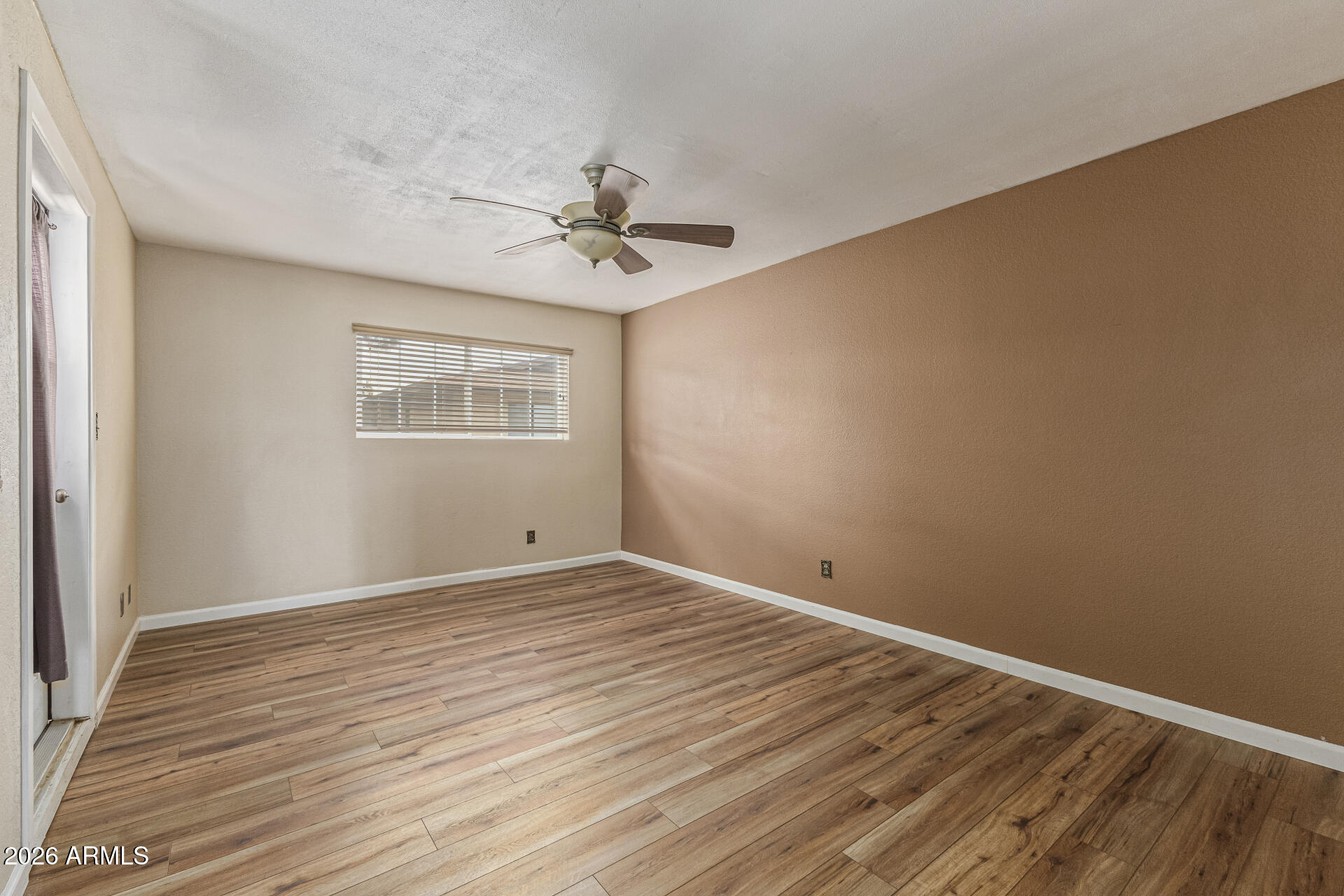 2930 North 22nd Place Phoenix, AZ 85016 - Photo 21 of 41 a view of empty room with wooden floor and fan