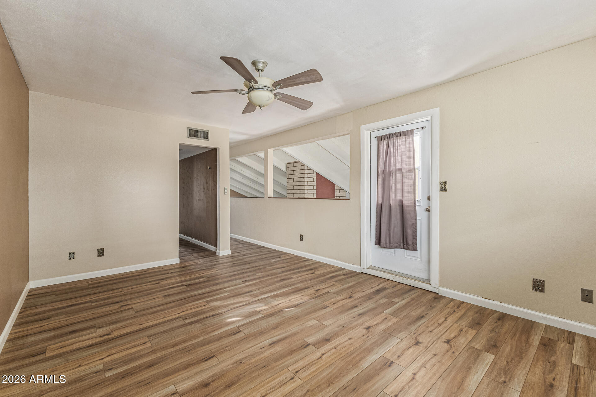 2930 North 22nd Place Phoenix, AZ 85016 - Photo 22 of 41 a view of an empty room with wooden floor and a window