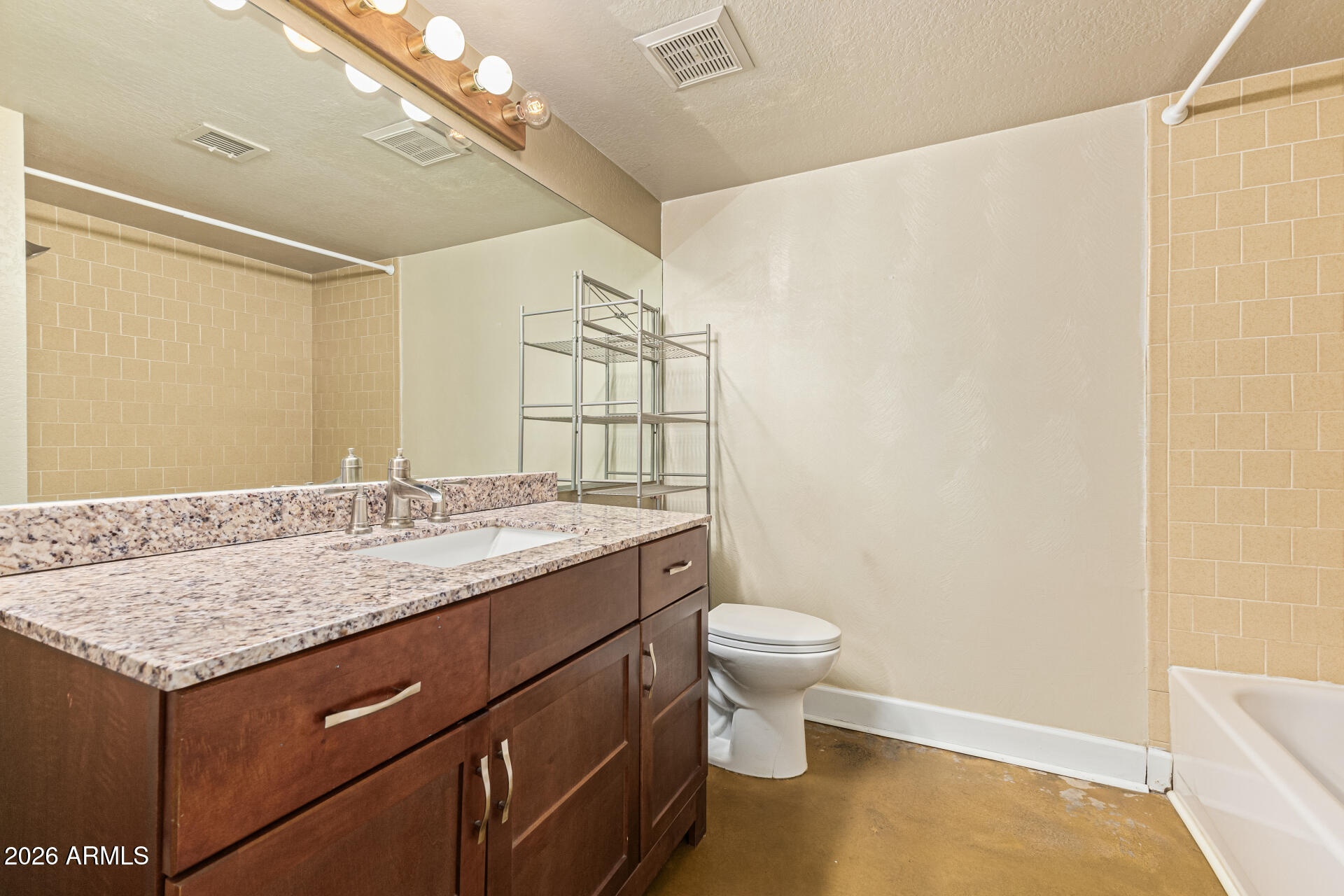 2930 North 22nd Place Phoenix, AZ 85016 - Photo 33 of 41 a bathroom with a granite countertop sink a toilet and shower