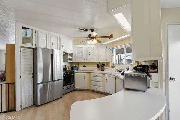 a kitchen with stainless steel appliances a refrigerator sink and stove