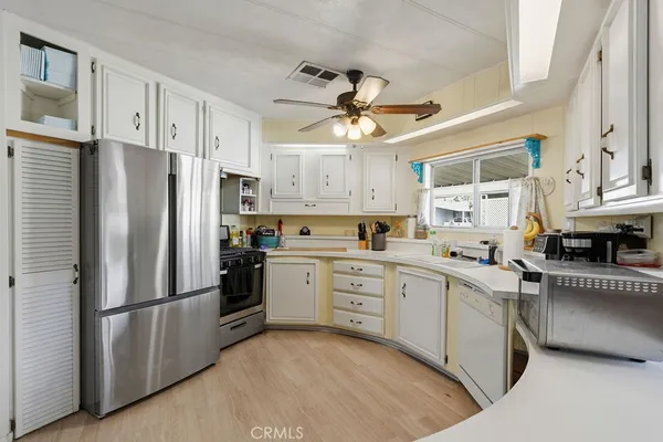 a kitchen with stainless steel appliances a refrigerator sink and cabinets