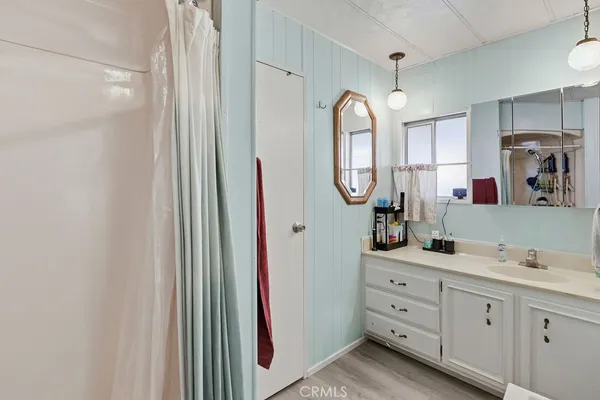 a spacious bathroom with a double vanity sink and a mirror