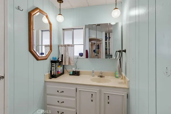 a bathroom with a double vanity sink and a mirror