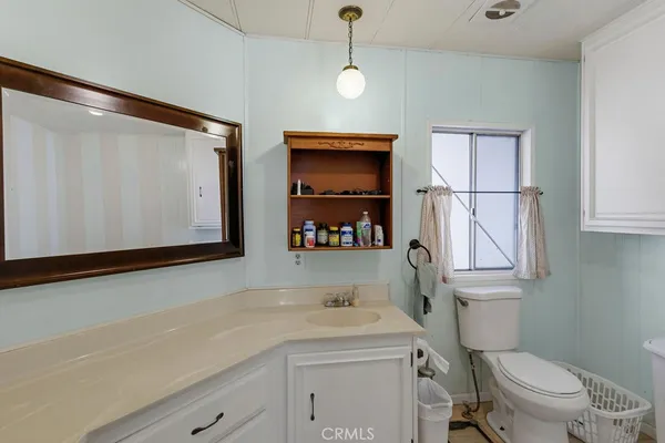 a bathroom with a sink a toilet and vanity