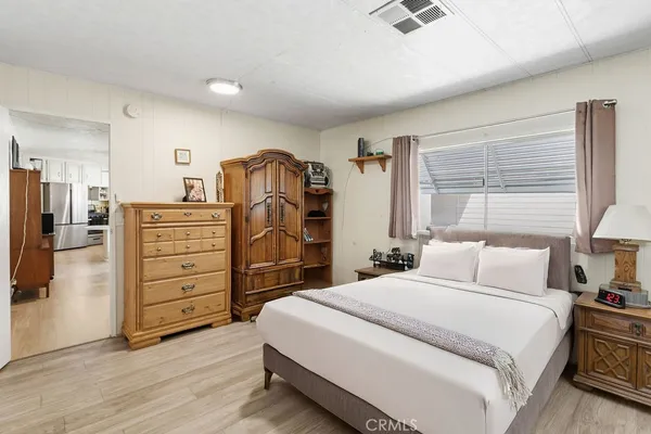 a bedroom with a bed and a dresser