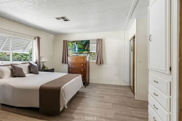 a bedroom with a large bed and a window