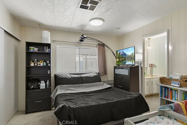 a bedroom with a bed and a book shelf