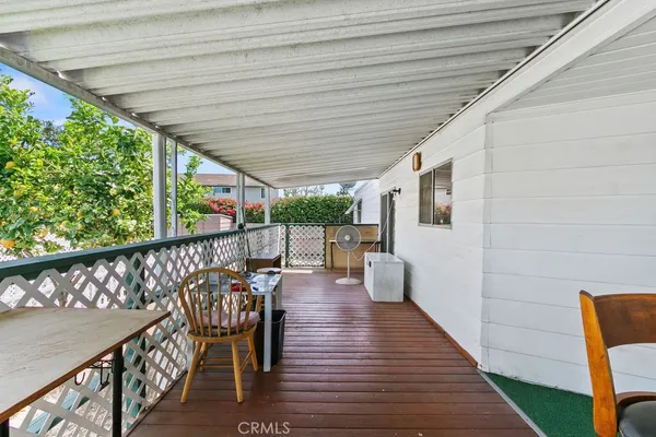a balcony with chairs and wooden floor