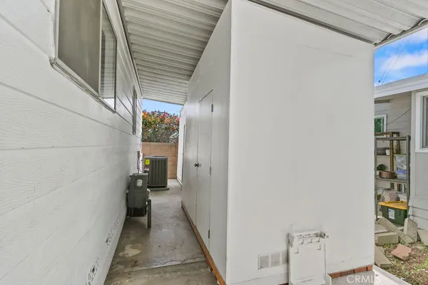 a view of a hallway with wooden shelves and stairs