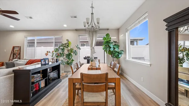 a dining room with furniture and a chandelier