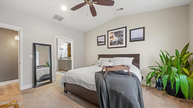 a bed sitting in a bedroom and next to a bedroom