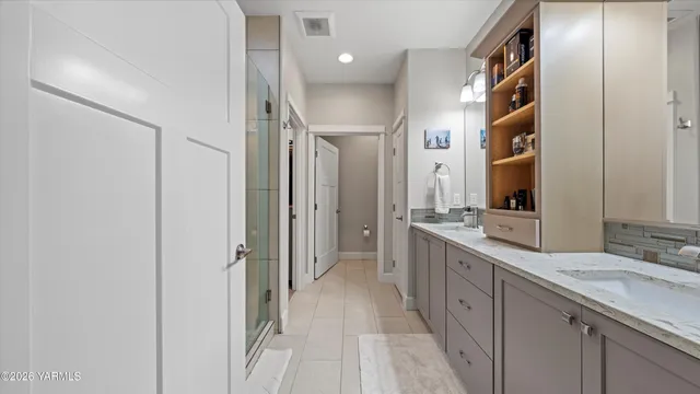 a spacious bathroom with a double vanity sink shower and a mirror