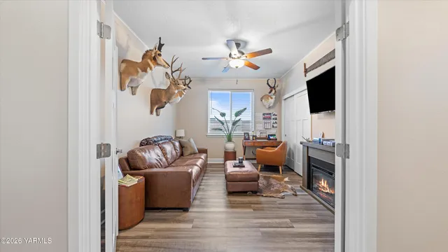 a living room with furniture a flat screen tv and a fireplace