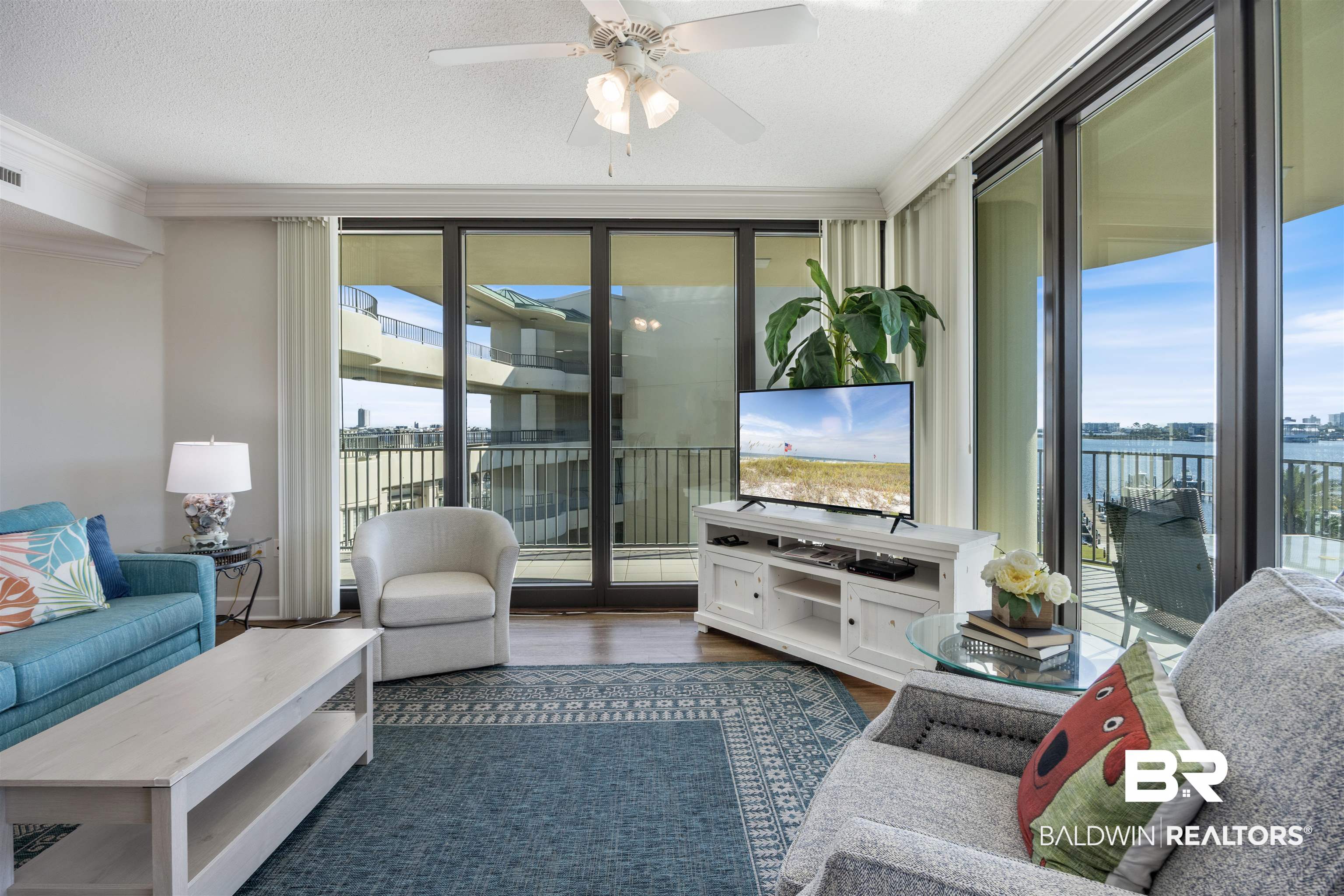 27580 Canal Road, Unit 1431 Orange Beach, AL 36561 - Photo 10 of 73 Living area featuring dark wood-type flooring, crown molding, a textured ceiling, and a ceiling fan
