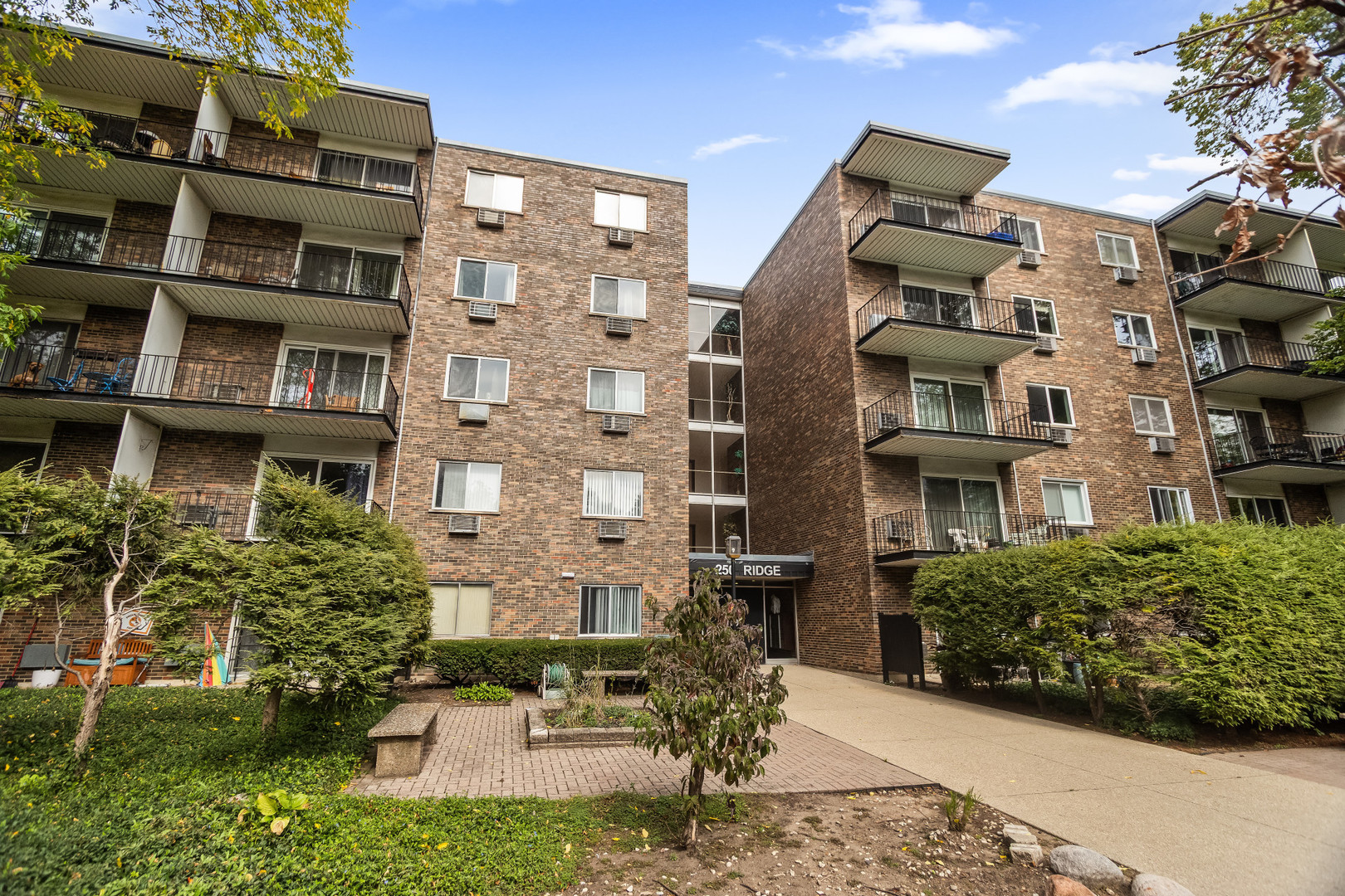 250 Ridge Avenue, Unit 2J Evanston, IL 60202 - Photo 16 of 18 a front view of a building with a garden