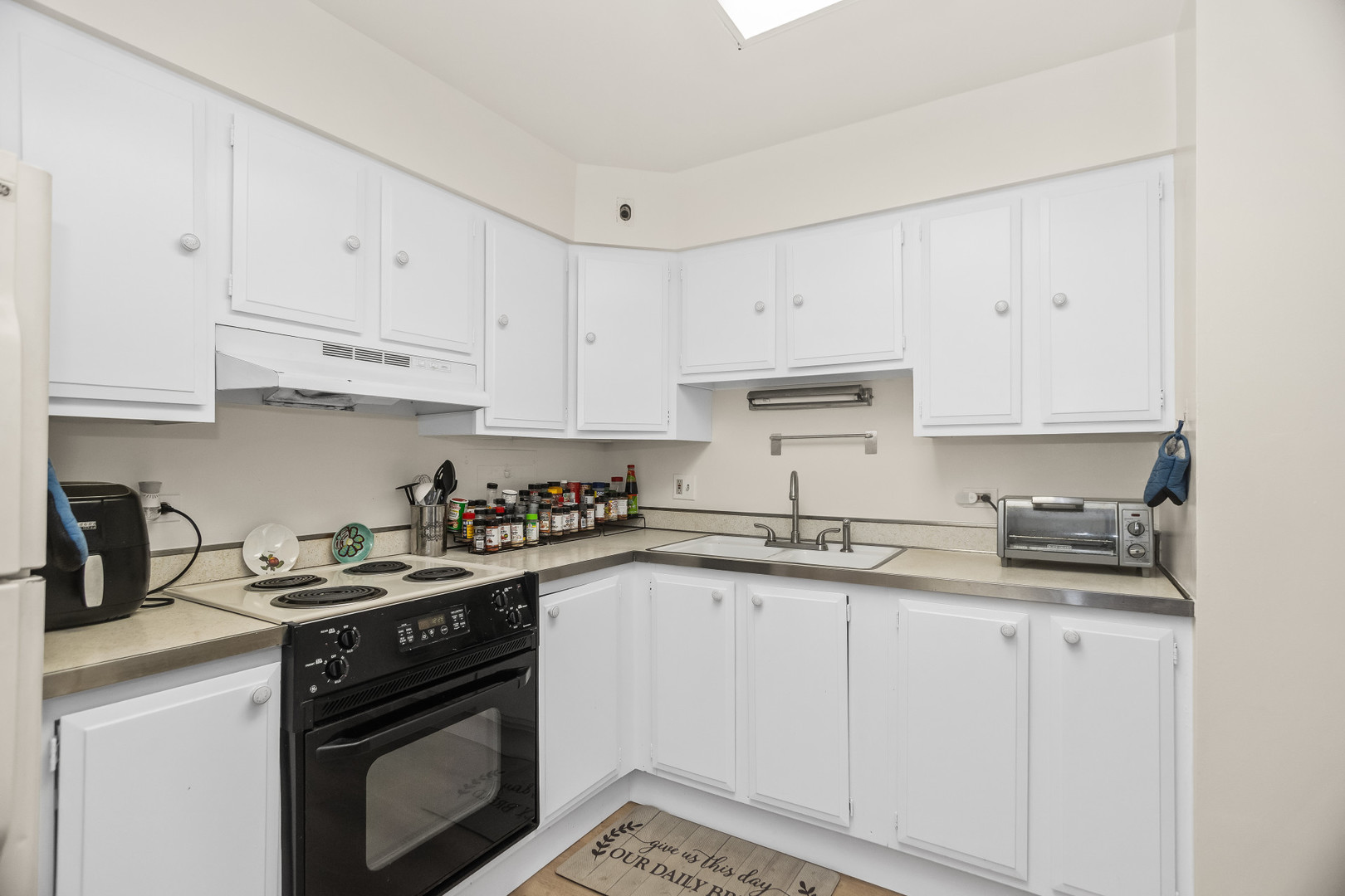 250 Ridge Avenue, Unit 2J Evanston, IL 60202 - Photo 8 of 18 a kitchen with granite countertop white cabinets and white appliances
