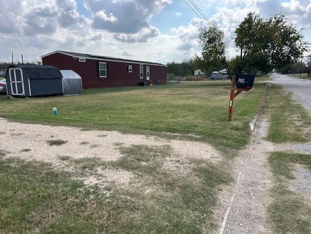 a view of a big yard with a house