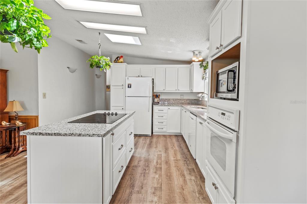 83 Eagle Circle Ellenton, FL 34222 - Photo 12 of 60 a kitchen with granite countertop a white stove top oven and refrigerator