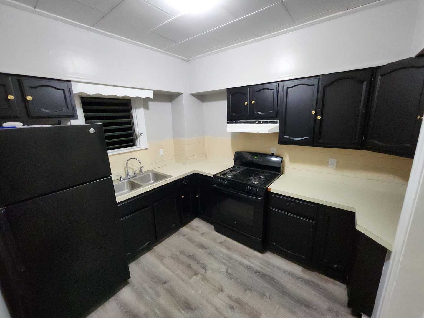 509 Fifth Street Aurora, IL 60505 - Photo 4 of 6 a kitchen with a refrigerator and a stove top oven