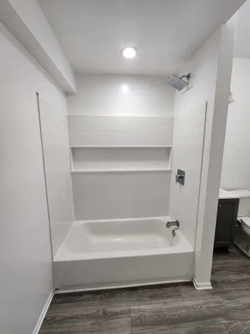 a bathroom with a bathtub and a shower