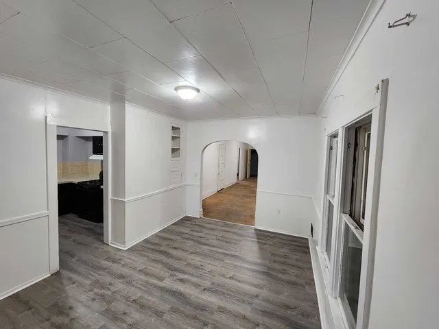a view of hallway with wooden floor