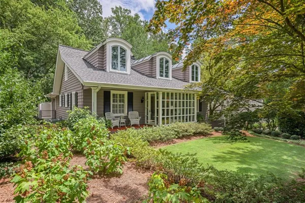 a front view of a house with garden