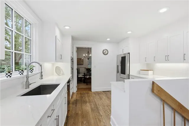a living room with furniture a fireplace and a potted plant