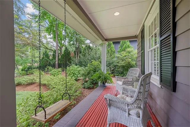a front view of a house with a yard and potted plants