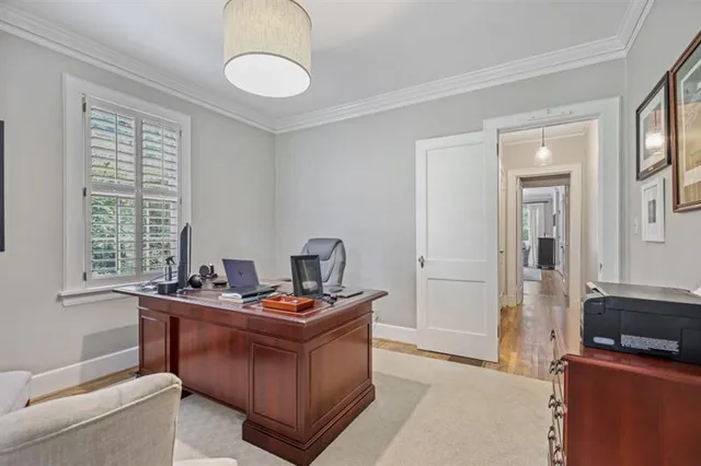 a living room with furniture a window and gym equipment