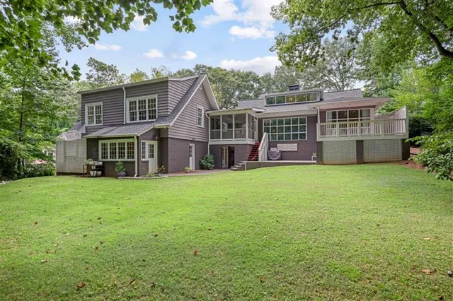 a kitchen with stainless steel appliances white cabinets and a window
