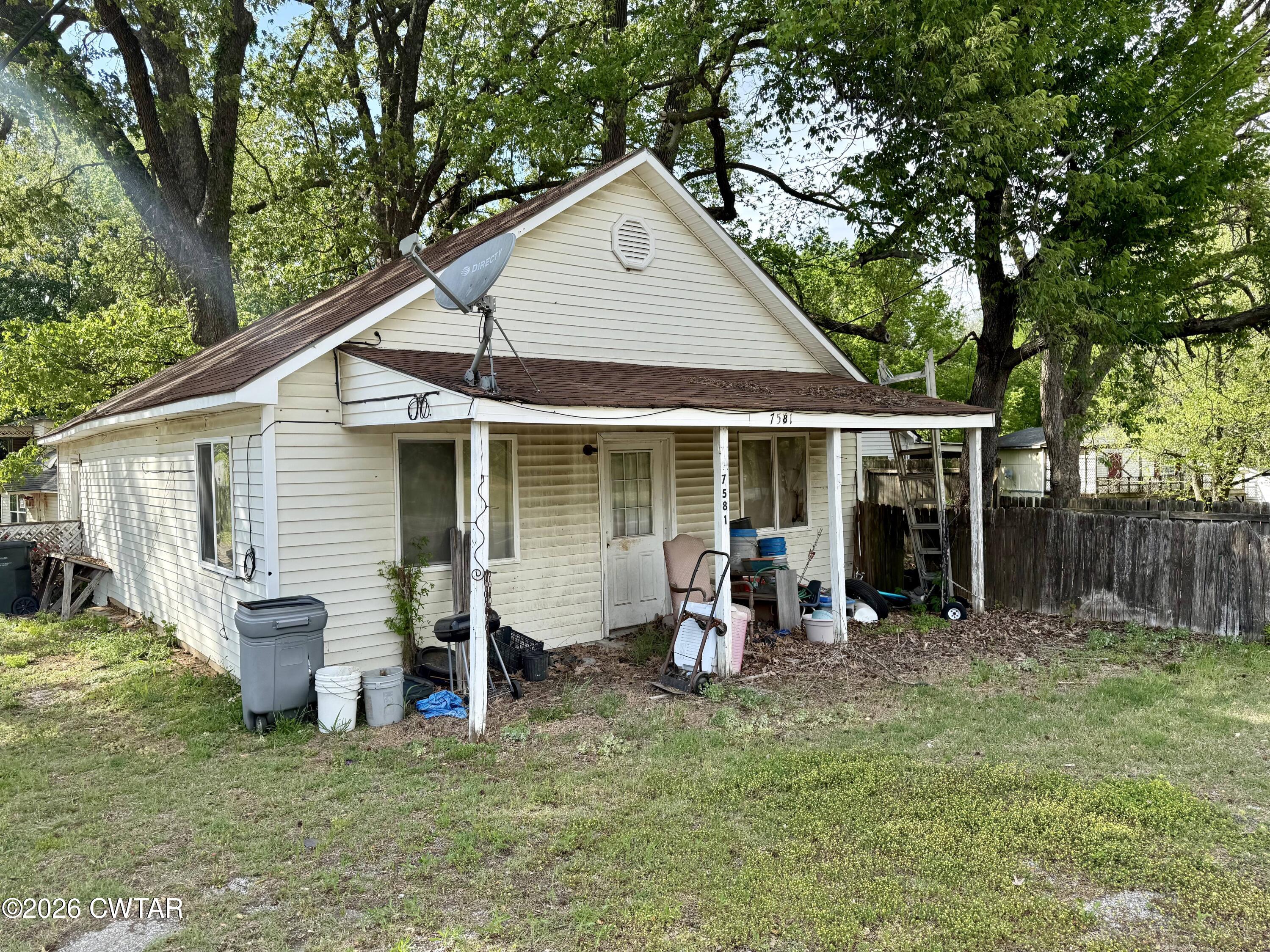 7581 Highway 189 Friendship, TN 38034 - Photo 2 of 8 a front view of house with yard outdoor seating and barbeque oven