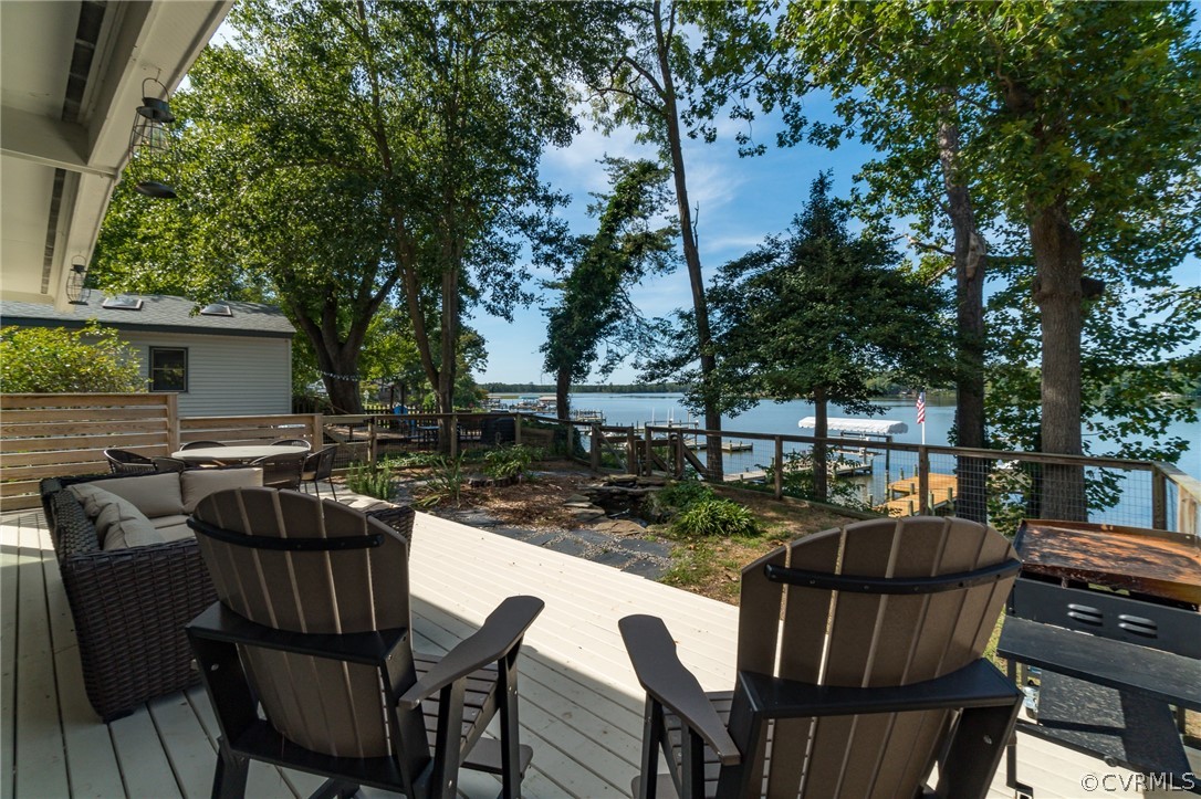 6279 Holly Trail Gloucester, VA 23061 - Photo 31 of 45 a view of a patio with table and chairs with wooden floor and fence