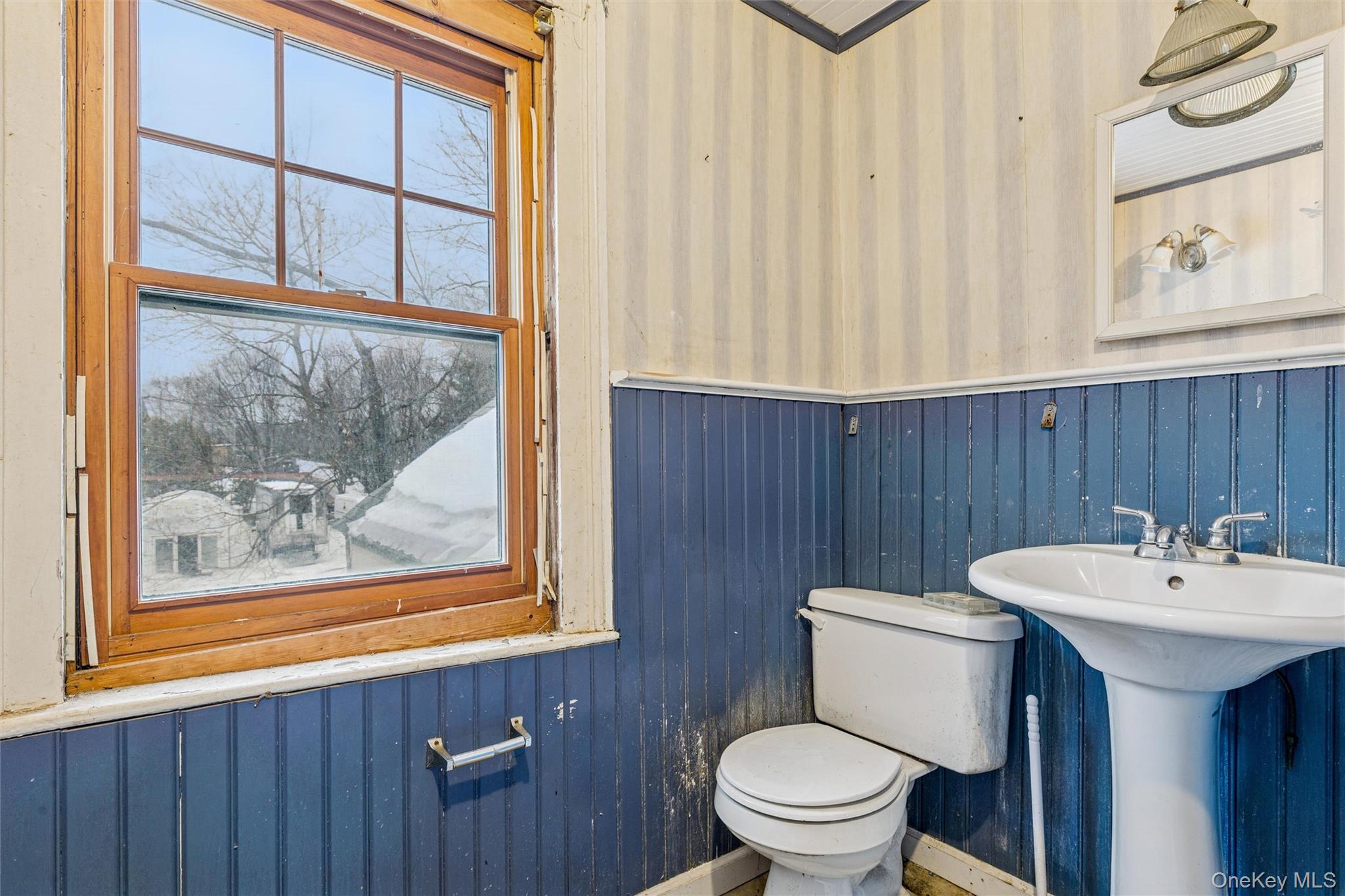 250 Main Road Riverhead, NY 11901 - Photo 24 of 31 a bathroom with a toilet a sink and a window