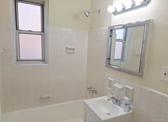 a bathroom with a sink a mirror and shower
