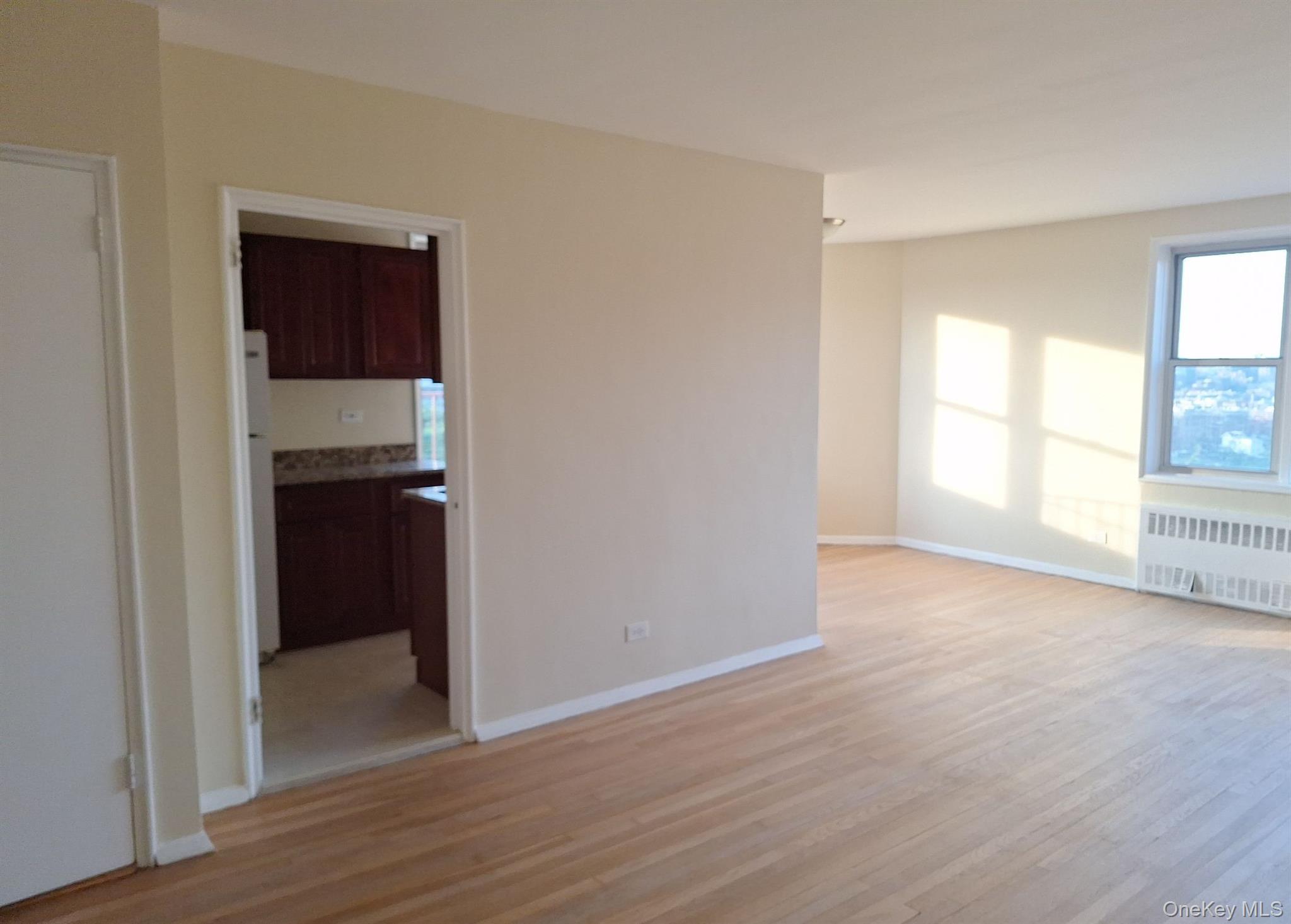 3475 Greystone Avenue, Unit 7E Bronx, NY 10463 - Photo 7 of 12 a view of an empty room with wooden floor and a window