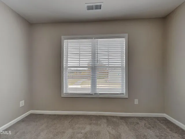 a view of an empty room and closet area