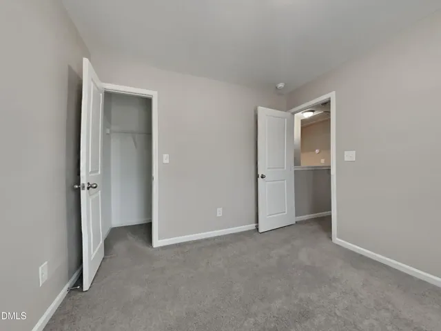 a view of an empty room and closet area