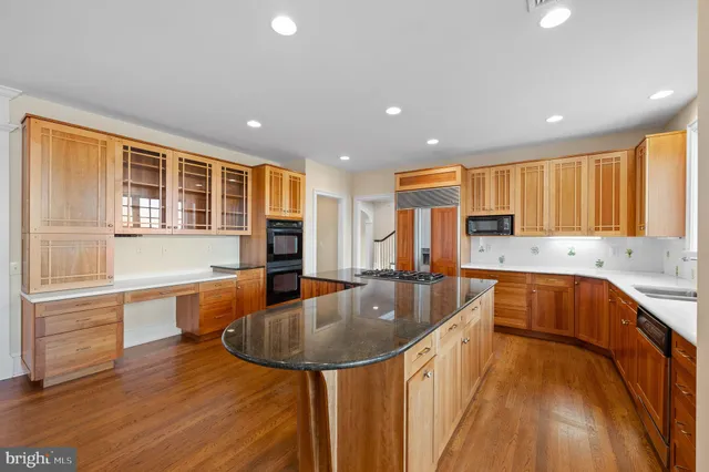a kitchen with stainless steel appliances granite countertop a stove and a large refrigerator