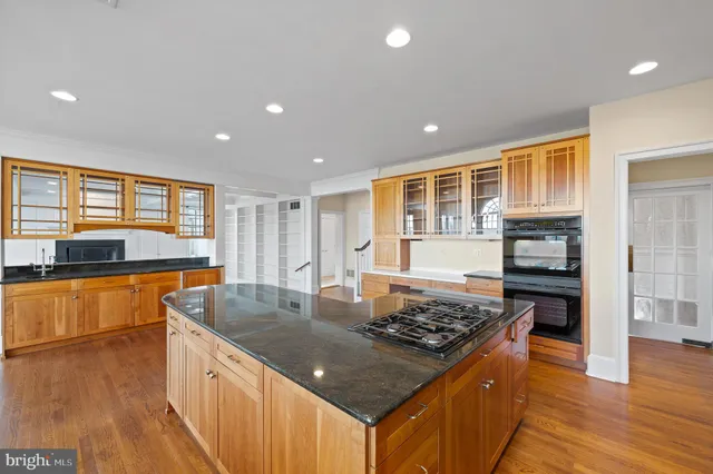 a large kitchen with a large window and stainless steel appliances