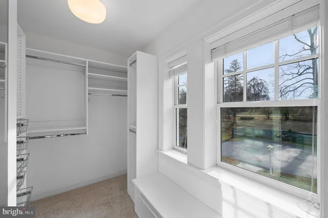 a spacious bedroom with a bed and a dresser