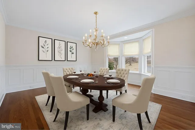 a kitchen with a dining table chairs sink and cabinets