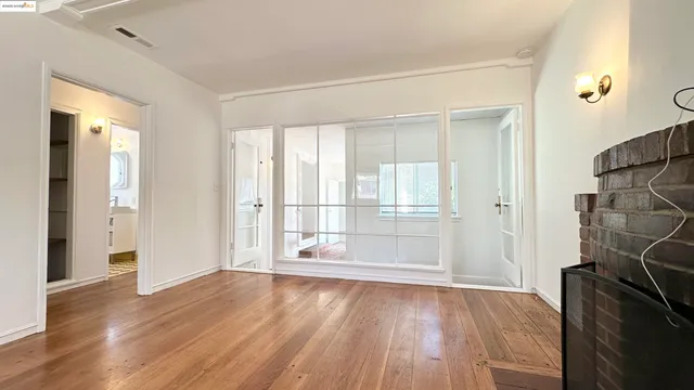 wooden floor in an empty room with a window