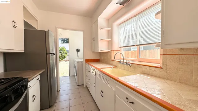 a kitchen with a sink stove and refrigerator
