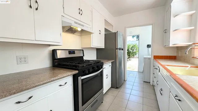 a kitchen with stainless steel appliances granite countertop a sink and a stove