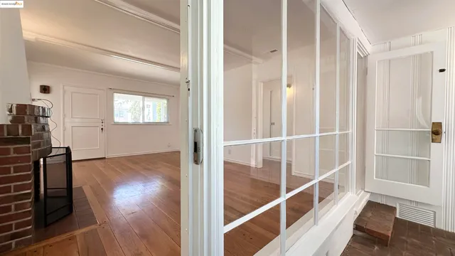a view of a livingroom with wooden floor and staircase