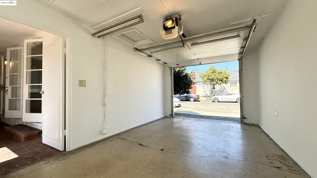 a view of a hallway with wooden floor and a glass door